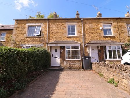 A house with a front door and windows at Mallards Bourton-On-The-Water