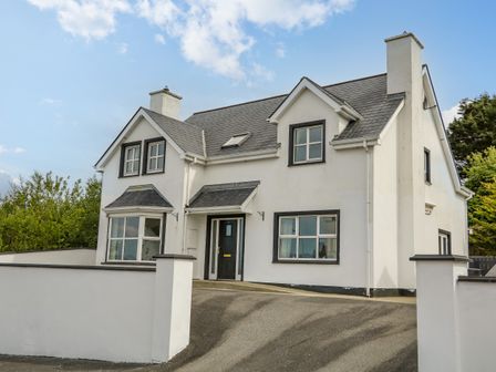 A two-story house with a driveway and white walls at 12 Hillview in Ludden near Buncrana