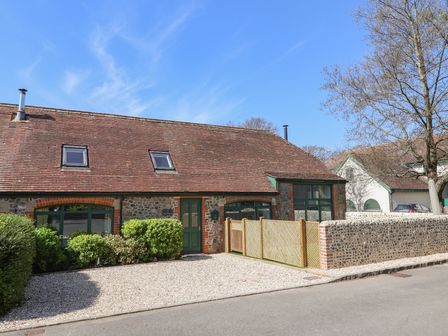 A stone house with green windows and doors and a gravel driveway at 2 Engine House in Rousdon near Lyme Regis