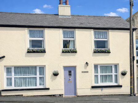 A house facade with windows and a door at Waterfall Cottage in Dyserth