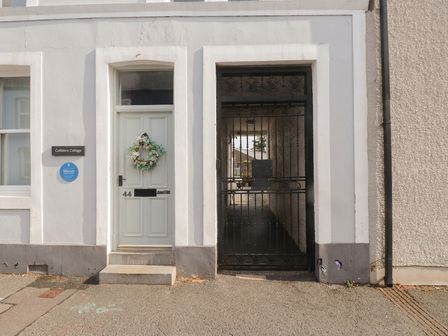 An entrance with a door and gate at Cobblers Cottage in Beaumaris