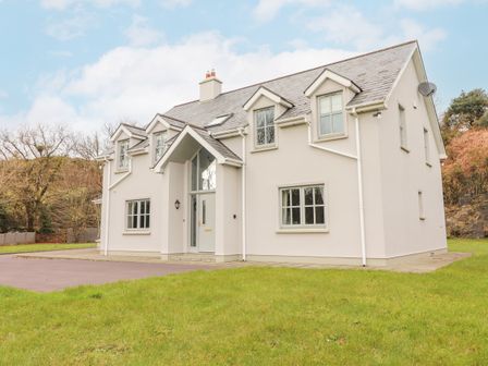 A two story house with multiple windows and a front entrance on a lawn at Hazelwood in Leap County Cork