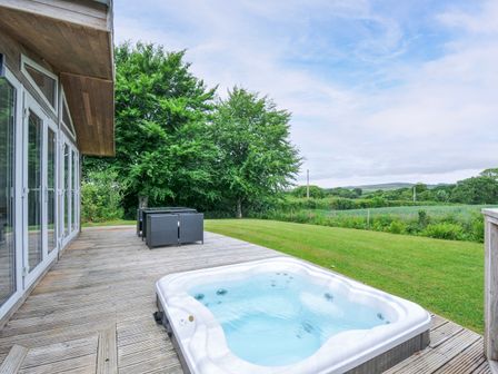 An outdoor area with a hot tub and seating at 1 Horizon View in Dobwalls