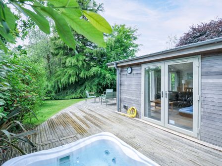 An outdoor area with a hot tub and deck at 15 Horizon View in Dobwalls