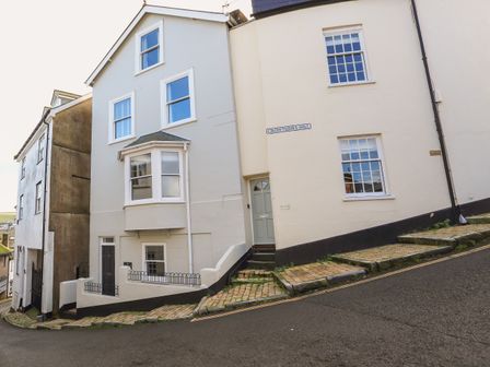 A street view of houses on a steep hill with windows doors and stone steps at Seaview in Dartmouth