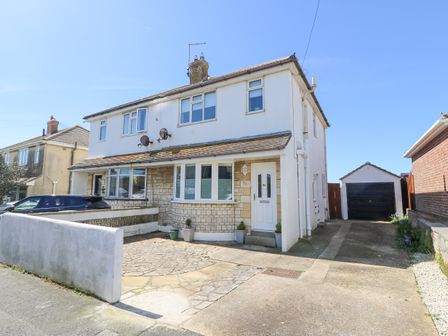 A semi detached house with a driveway and a garage at Lagoon View in Wyke