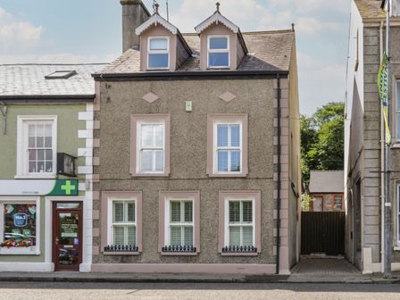 A three-story building with six windows and an entrance on a street at The River House in Ramelton County Donegal