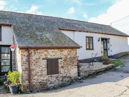An exterior view of a building with stone and white walls and a sloped roof at Pillhead Cider House in Bideford