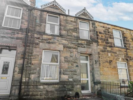A stone building with a door and windows at Hardys House in Alnwick