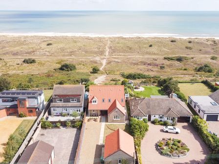 Aerial view of houses with gardens near a beach and dunes at Drifters in Winterton-On-Sea