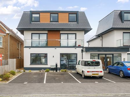 A modern two story house with parking spaces and cars in front at Mary Bowes Terrace in Southbourne