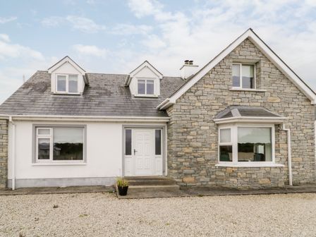 A house with stone and white walls and a gravel driveway at The Glen in Carndonagh County Donegal