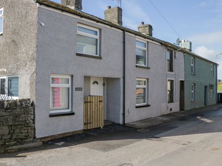 Exterior view of a row of terraced houses along a street including Crag View Cottage in Stainton with Adgarley near Dalton-In-Furness