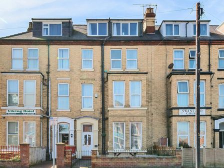 A row of brick buildings with multiple windows including Viking Hotel and Swanland Court at Bridlington Bay House in Bridlington