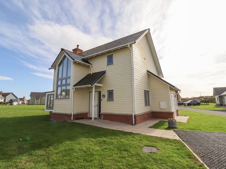 An exterior view of a house with a garden at The Beach House in Beadnell