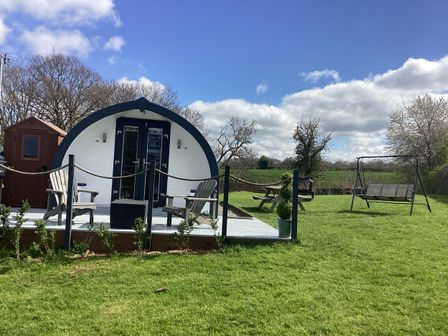 A cabin with deck chairs and a swing at Cherry Pod 2 Hookagate near Meole Brace