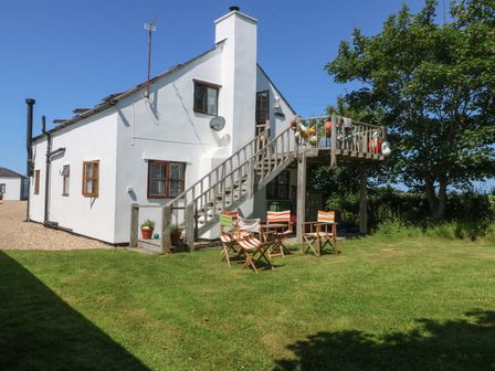 An outdoor area with chairs and stairs at Borth Arian Boat House in Holyhead