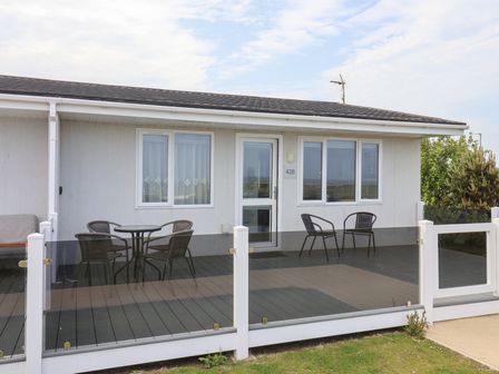 An outdoor area with a deck and seating at Bonny Bay in Wilsthorpe near Bridlington