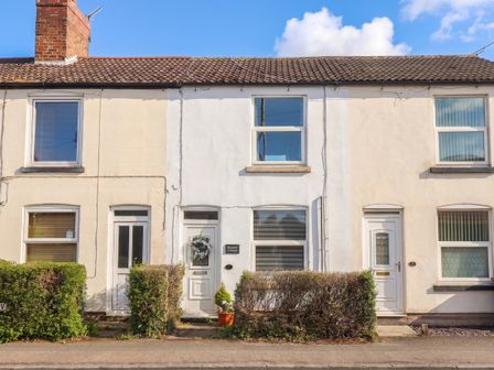 A building facade with front doors and windows at Bluebell Cottage in Brayton