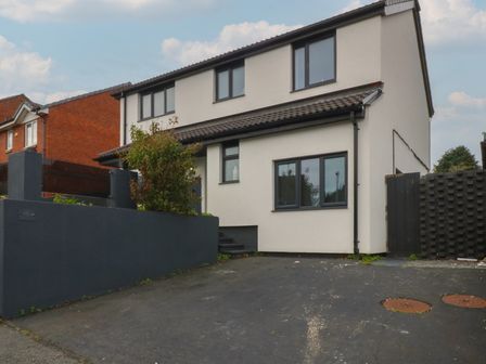 A house with windows and a driveway at 2 Trem Y Don, Colwyn Bay