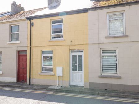A row of terraced houses with different colored doors and windows at 22 Town Place in Ballinrobe County Mayo