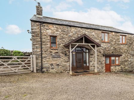 A stone house with front door and windows at Horse and Farrier Barn in Newton in Cartmel near Cartmel