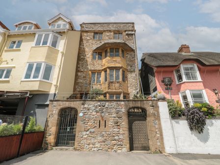Three attached houses with different architectural styles and materials in a row