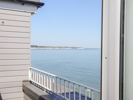 A view of the sea with a distant coastline and part of a balcony with a white railing at 8 Seaview @ Bridlington Bay Bridlington