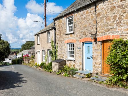 A street with stone cottages and blue sky at Stokes Cottage in St Minver