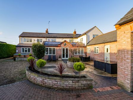 An outdoor courtyard with a patio garden and seating area at Home Farm Cottage Stockton near Napton-On-The-Hill