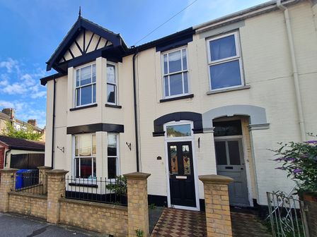 Front view of a terraced house with bay windows and brick fence at Sunrise House in Pakefield near Lowestoft