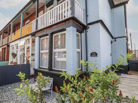 A blue brick house with white window blinds and a small garden area at 11a Manning Road Felixstowe Suffolk