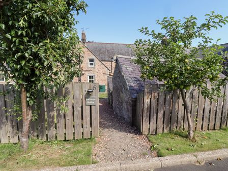 An entrance with a gate and pathway at Bruno's Bothy Middleton near Belford