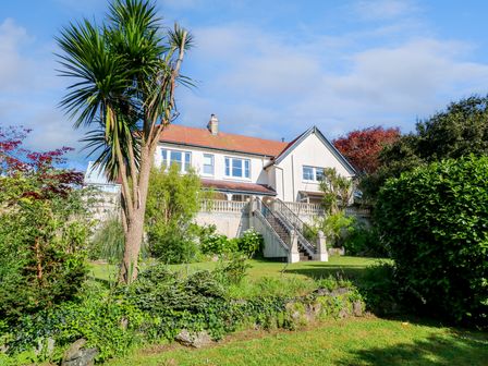 A house with stairs and a garden with trees and shrubs at Hindon Hall in Lelant near Carbis Bay