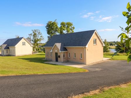 A house with a driveway and grass at 30 River Run, Belturbet, County Cavan
