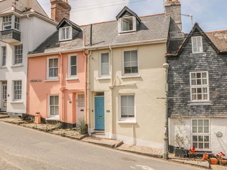 A row of three connected houses on a street with different colored facades at Topsail in Dartmouth