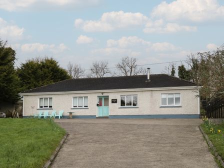 A single story house with a driveway and blue chairs outside at Sheemore View Sheffield near Leitrim County Leitrim
