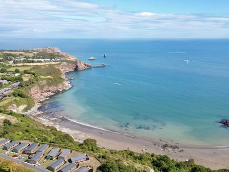 An outdoor view of the beach and sea at Lodge 67 at Riviera Bay Coastal Retreat Brixham