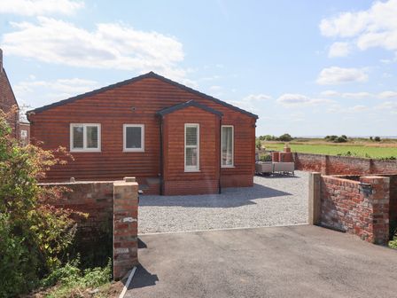 A house with gravel driveway and furniture at Waverley Cottage Kilnsea near Easington, Hull
