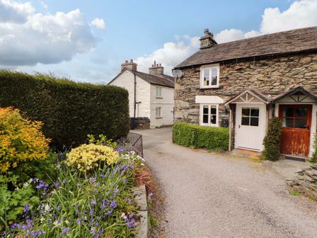 A house with a flower bed and pathway at Byways Ambleside