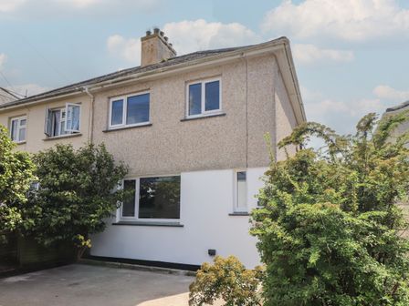A two storey semi detached house with a driveway and shrubs at The Heights in Truro