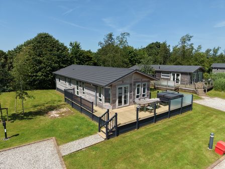 A lodge with decking and garden area at 4 Meadow Retreat in Dobwalls