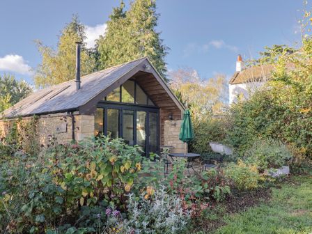A house with a garden and outdoor seating at The Cart Shed in Barwick near Yeovil, Somerset