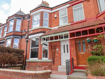 A brick terraced house with a white front door and bay windows at 32 Ashville Avenue in Scarborough