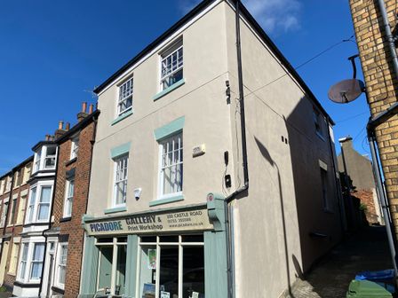 A street view of a building with a sign reading Picadore Gallery and Print Workshop at Picadore Two in Scarborough