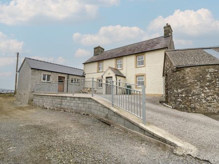 A two story house with a ramp and railing outside near Newport Beach Pembrokeshire