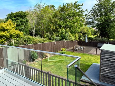 A garden with a deck and seating area at The Swanage Rail Lookout in Swanage