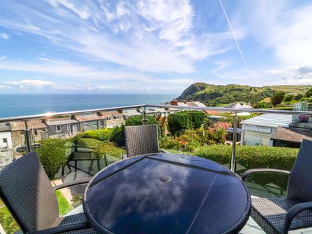An outdoor seating area overlooking the sea at Combe View in Ilfracombe