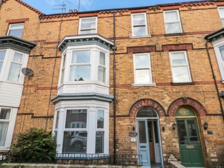 A building exterior with bay windows and front doors at Seascape Villa in Filey