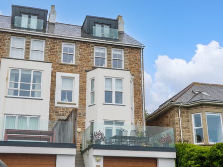 A residential building with balconies and glass railings at Amelias Point in St Ives
